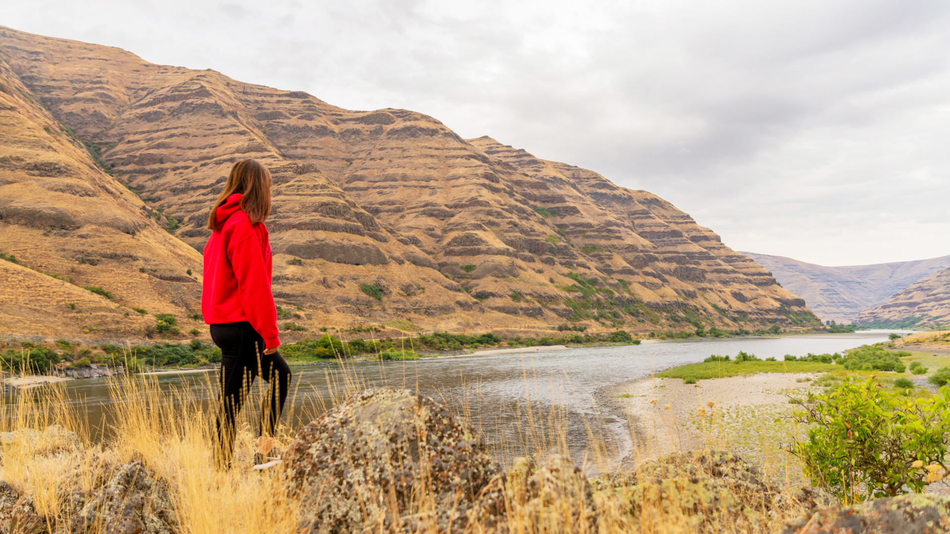 Female student looking at Snake River and hill formation